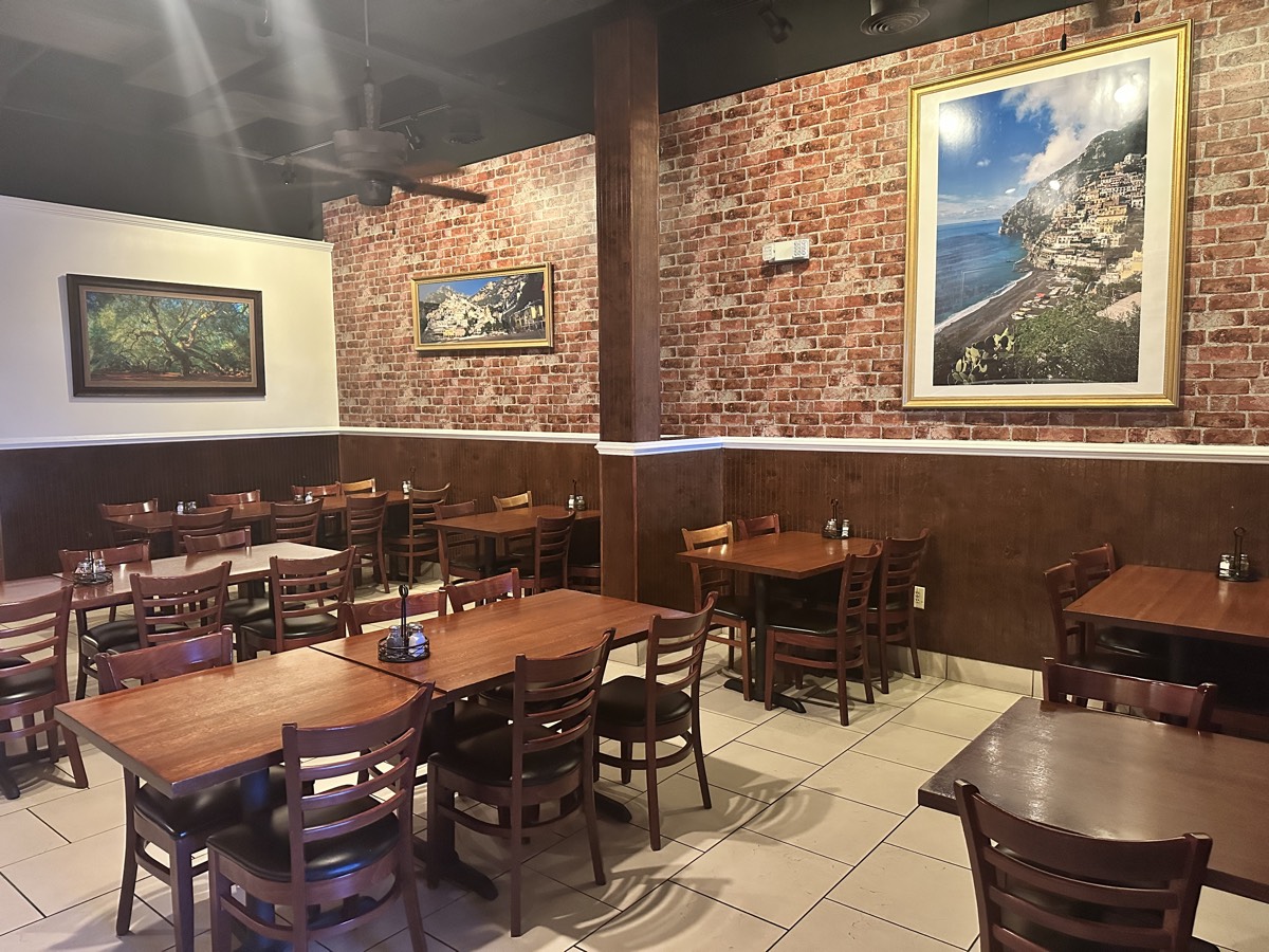 Capriccio Italian restaurant interior with coastal artwork and ceiling fans